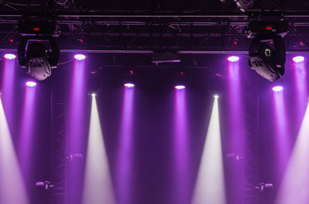 A view from above of the ceiling of a concert stage with  purple and white spotlights on a Stage...