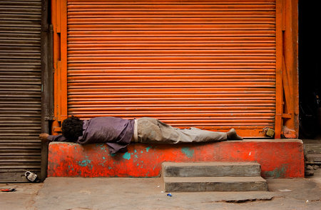 The poor man sleeping in the street open-air, India, Delhi.の写真素材