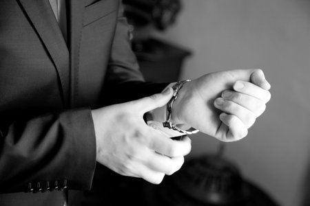 The groom,  man clasps a button at a jacketの写真素材