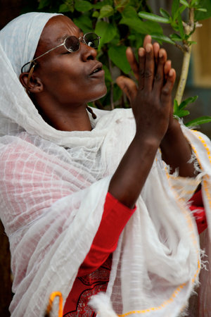 TURMI, ETHIOPIA - NOVEMBER 22, 2011: The woman prays during celebration in orthodox church. November 22, 2011 in Turmi, Ethiopia.のeditorial素材