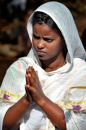 TURMI, ETHIOPIA - NOVEMBER 22, 2011: The woman prays during celebration in orthodox church. November 22, 2011 in Turmi, Ethiopia.のeditorial素材