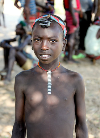 SOUTH OMO - ETHIOPIA - November 19, 2011: Unidentified Hamer boy on November 19, 2014 in South Omo, Ethiopia. The boy's portrait from a tribe a hamer, Ethiopia.のeditorial素材