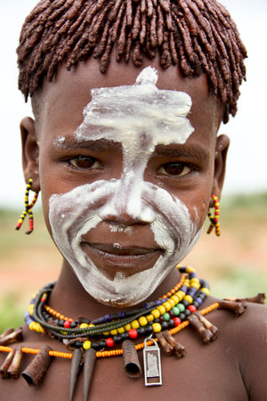 SOUTH OMO - ETHIOPIA - November 24, 2011: Unidentified Hamer boy on November 24, 2014 in South Omo, Ethiopia. The boy's portrait from a tribe a hamer, Ethiopia.のeditorial素材