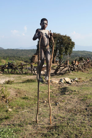 SOUTH OMO - ETHIOPIA - November 19, 2011: Unidentified Hamer boy on stilts on November 19, 2014 in...