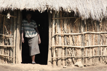 AWASSA, ETHIOPIA - NOVEMBER 26, 2011. Unidentified Ethiopian women on a threshold of the house.のeditorial素材