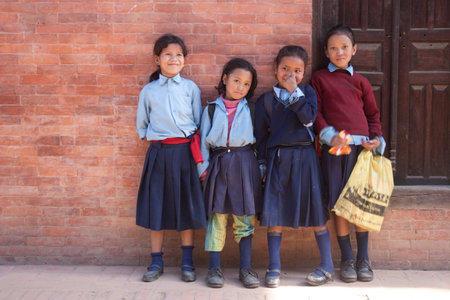 Pokhara, NEPAL - NOVEMBER 03, 2006: Nepalese schoolgirl on the street of the town Pokhara, Nepal.のeditorial素材