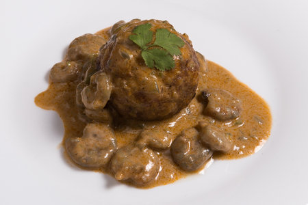 Latino american main course mofongo with shrimps and broth close-up on a plate on white background