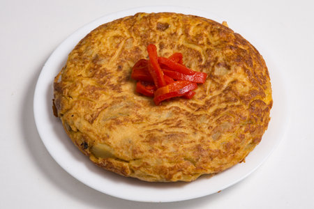 Spanish omelet Tortilla de patata isolated on a white plateの写真素材