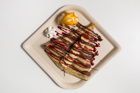 Tasty crepe with hazelnut chocolate spread, banana and ice creamの写真素材