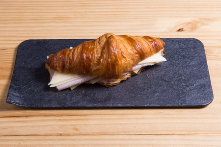 Sandwich with ham and cheese on croissant bun. Tasty croissant sandwich.の写真素材