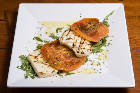 Lebanese food starter labneh slices topped with tomato and olive oil. A photo of a very typical dish...