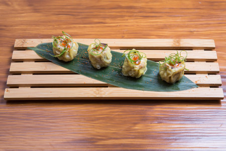 Japanese gyoza dumplings on wood background. Traditional asian food. Cooked dim sum の写真素材