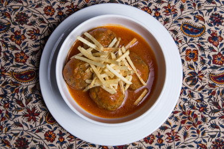 Iranian cuisine Oshe Anor, meatball soup, white plate