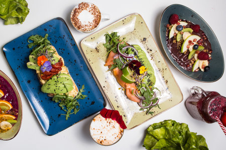 Set with dishes from healthy food restaurant toast with avocado, eggs, acai bowl.