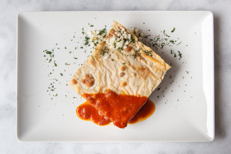 Greek traditional mousaka with meat on a white plateの写真素材