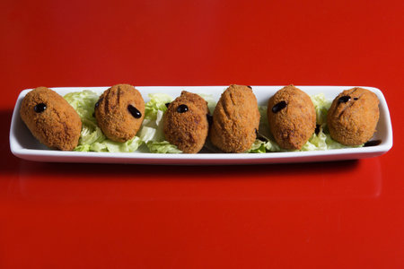 Croquetas con jamon typical spanish meal on a white plate