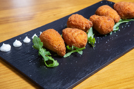 Potato croquettes croquetas in a black plate. Fast Foodの写真素材
