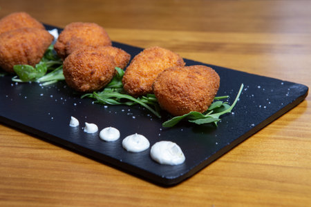 Potato croquettes croquetas in a black plate. Fast Foodの写真素材