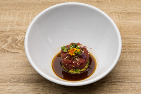 Tuna and avocado tartar with toast and soy sauce.