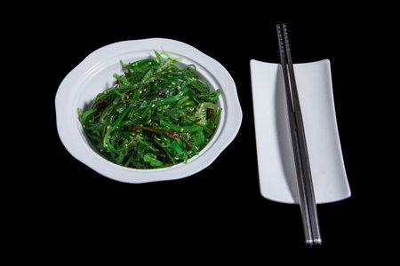 Salad from green sea alga in an oval white plateの写真素材