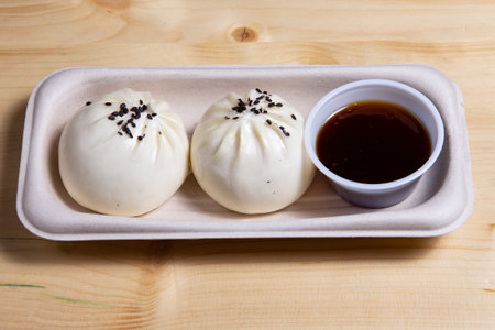 Steamed Chicken Xiao Long Bao in a  paper plate