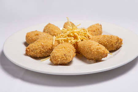 Potato croquettes (croquetas) with ham on a white plate. Fast Food.の写真素材