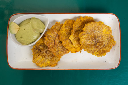 Patacon or toston, fried and flattened pieces of green plantains, a traditional snack or accompaniment in the Caribbeanの写真素材