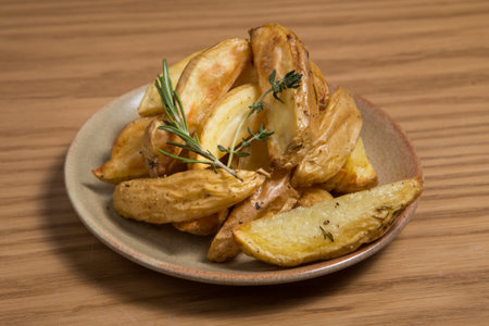 Tasty homemade potato wedges on a plate.