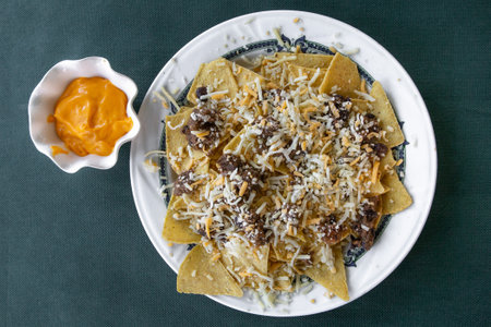 Nachos with sour cream, guacamole, black beans, cheese and jalapenosの写真素材