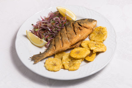 Baked fish called Dorada with banana friesの写真素材