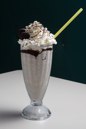 Sweet chocolate cocktail with whipped cream and crashed oreo cakes served in long glass.の写真素材
