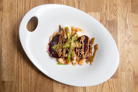 Warm vegetable salad with been on a white plate