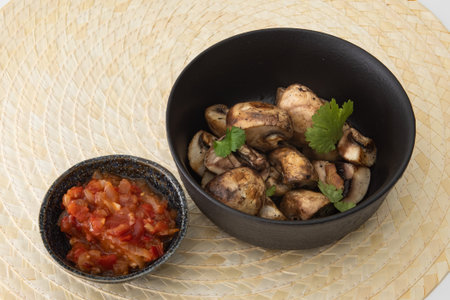 Grilled Mushrooms with tomato sauce on a plateの写真素材