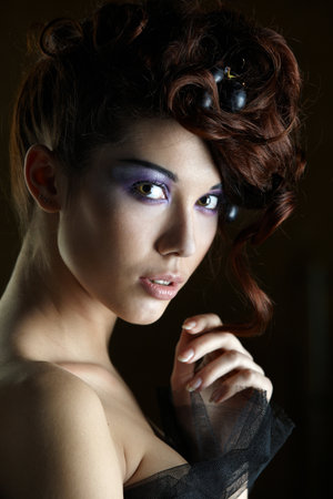 Girl model in a corset on a background wallpaper with flowers in her hair vineの写真素材