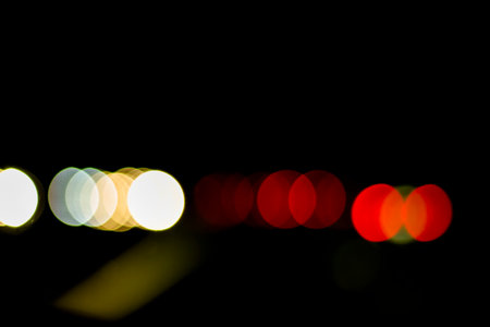 Traffic lights of the night city road. beautiful background of bokeh lights at night on road with...