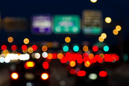 Traffic lights of the night city road. beautiful background of bokeh lights at night on road with carの写真素材