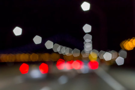 Traffic lights of the night city road. beautiful background of bokeh lights at night on road with carの写真素材