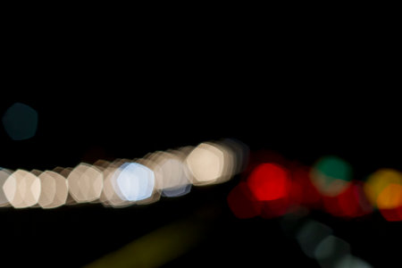 Traffic lights of the night city road. beautiful background of bokeh lights at night on road with...