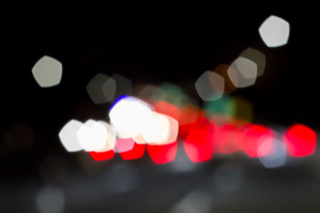 Traffic lights of the night city road. beautiful background of bokeh lights at night on road with carの写真素材