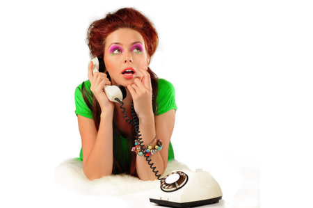  The stylish girl in a green dress is calling isolatedの写真素材