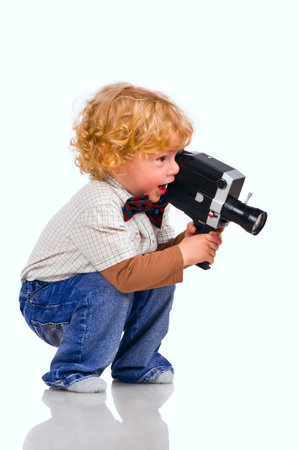The little boy with an old videocamera in hands の写真素材