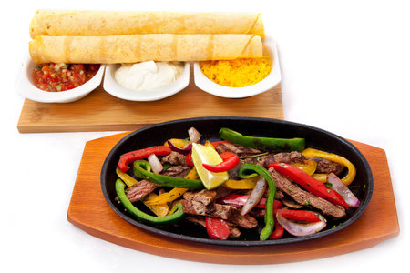 traditional mexican beef fajitas on isolated white backgroundの写真素材