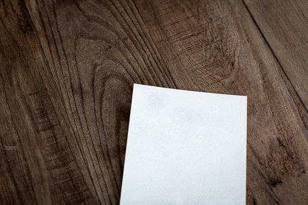 A piece of white paper on the wooden tableの写真素材