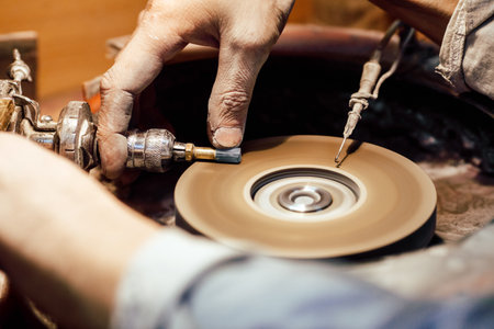 Polishing moonstone at the factory for the extraction and processing of precious stones. Soft selective focus.の写真素材