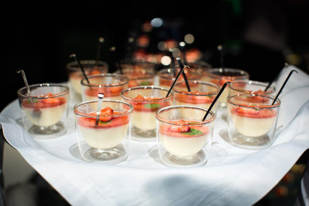 Desserts panna cotta with strawberry in glassesの写真素材