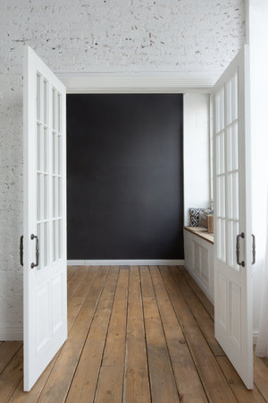Opened white doors in empty room