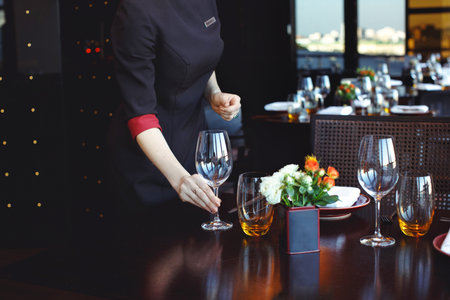 Waiter serving table in restaurantの写真素材