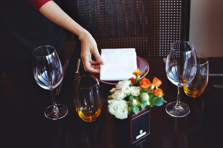 Waiter serving table in restaurantの写真素材