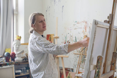 Creative male artist drawing picture oil paintsの写真素材