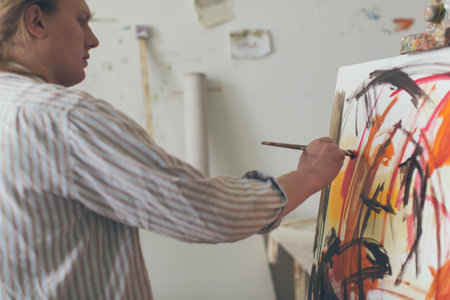 Creative male artist drawing picture oil paintsの写真素材